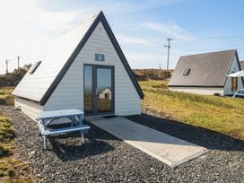 A cabin with a table in front and pathway at Cabin 9 Inish Beag, Gortahawk