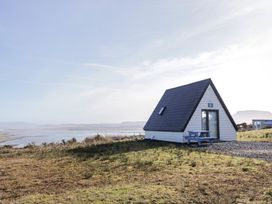 A cabin with a table and bench outdoors at Cabin 10 Inish Bo Finne in Gortahawk