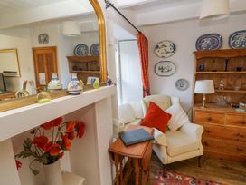 A living room with a table and chairs at St. Dominic Cottage in St. Ives