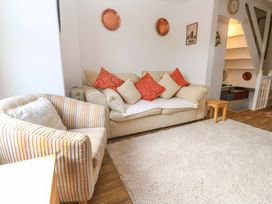 A living room with a sofa and armchair at St. Dominic Cottage in St. Ives