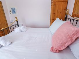 A bedroom with a bed and pillows at St. Dominic Cottage in St. Ives