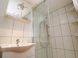 A bathroom with a sink and shower enclosure at St. Dominic Cottage St. Ives