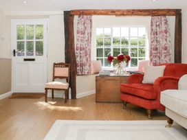 A living room with a door and window at Upper Frogpool Cottage in Crediton