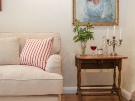A living room with a sofa and a table at Upper Frogpool Cottage in Crediton