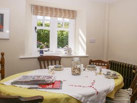 A dining room with a table and chairs at Upper Frogpool Cottage in Crediton