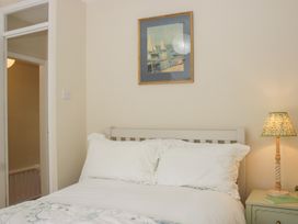 A bedroom with a bed and a bedside table at Upper Frogpool Cottage in Crediton