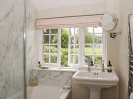 A bathroom with a sink and bathtub at Upper Frogpool Cottage in Crediton