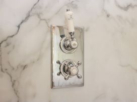 A shower control panel in a bathroom at Upper Frogpool Cottage Crediton