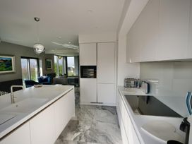 A kitchen with modern appliances and a sink at Midways in Windermere