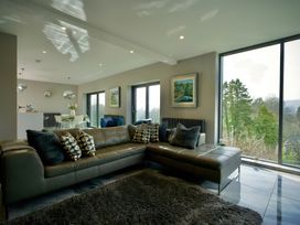 A living room with a sofa and artwork at Midways in Bowness-On-Windermere