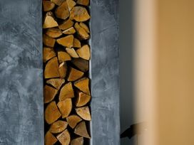 A storage space filled with wood logs at Midways in Bowness-On-Windermere