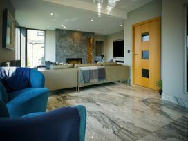 A living room with a sofa and fireplace at Midways, Bowness-On-Windermere