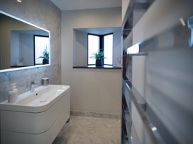 A bathroom with a sink and a window at Midways in Bowness-On-Windermere