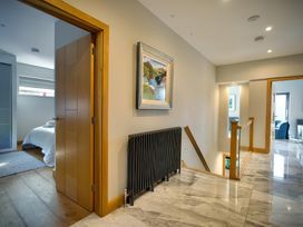 A hallway with a door and painting at Midways in Bowness-On-Windermere