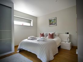 A bedroom with a bed and bedside table at Midways Bowness-On-Windermere