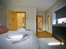 A bedroom with a bed and pillows at Midways in Bowness-On-Windermere