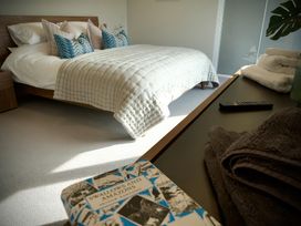 A bedroom with a bed and books at Midways in Bowness-On-Windermere