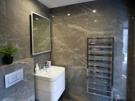 A bathroom with a sink and mirror at Midways in Bowness-On-Windermere