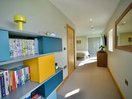 A bedroom with a shelf and books at Midways in Bowness-On-Windermere