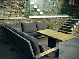 A seating area with a sofa and table at Midways, Bowness-On-Windermere