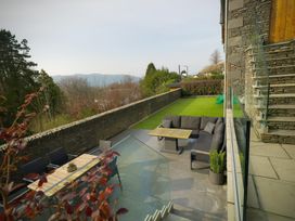 An outdoor area with a patio sofa and table at Midways in Bowness-On-Windermere
