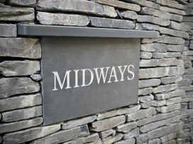 A sign on a stone wall at Midways in Bowness-On-Windermere
