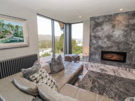 A living room with a sofa and fireplace at Midways in Bowness-On-Windermere