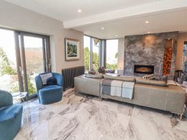 A living room with a sofa and armchairs at Midways in Bowness-On-Windermere