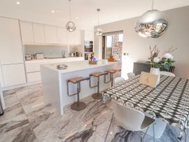 A kitchen with an island and bar stools at Midways in Bowness-On-Windermere