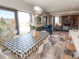 A dining room with a table and chairs at Midways in Bowness-On-Windermere