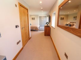 A bedroom with a bed and a wardrobe at Midways in Bowness-On-Windermere