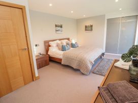 A bedroom with a double bed and bedside table at Midways Bowness-On-Windermere