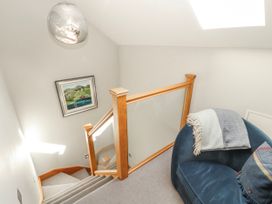 A staircase with a handrail and artwork at Midways in Bowness-On-Windermere