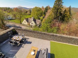An outdoor patio with a table and chairs at Midways in Bowness-On-Windermere