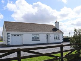 A house with a garage and yard at BREAGHMORE