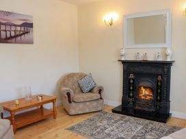 A living room with an armchair and fireplace at BREAGHMORE
