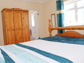 A bedroom with a bed and a wooden wardrobe at BREAGHMORE