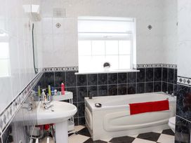 A bathroom with a bathtub, sink, and toilet at BREAGHMORE