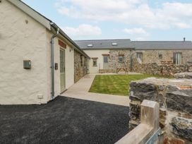An outdoor view of buildings and lawn at Barley Cottage Oxwich