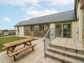 An outdoor area with a picnic table and steps at Barley Cottage in Oxwich