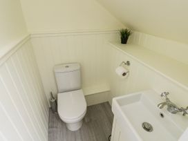 A bathroom with a toilet and sink at Barley Cottage Oxwich