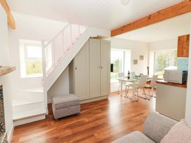 A living room with a staircase and dining area at Turraheen in Cashel