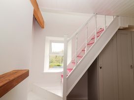 A staircase with a window and cupboards at Turraheen in Cashel