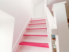 A staircase with pink steps and a handrail at Turraheen in Cashel