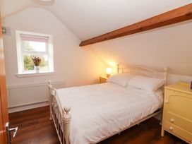 A bedroom with a bed and window at Turraheen in Cashel