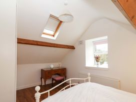 A bedroom with a bed and a desk at Turraheen in Cashel