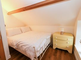 A bedroom with a bed and a nightstand at Turraheen in Cashel