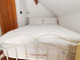 A bed with white bedding and pillows at Turraheen in Cashel
