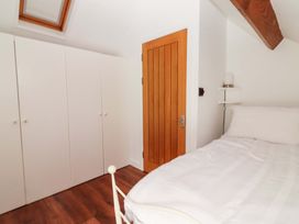 A bedroom with a bed and wardrobe at Turraheen in Cashel