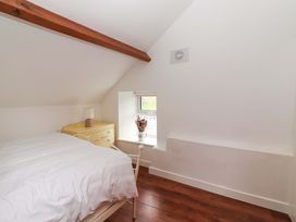 A bedroom with a bed and dresser at Turraheen in Cashel